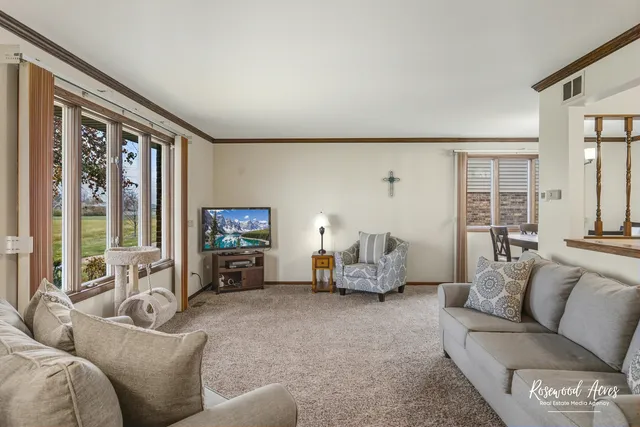 a living room with furniture and large windows
