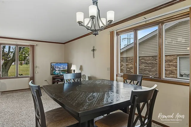 a view of a dining room with furniture window and outside view