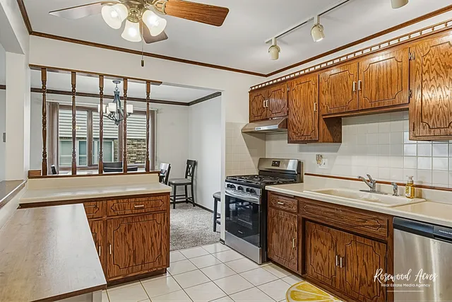 a kitchen with a sink stove and cabinets