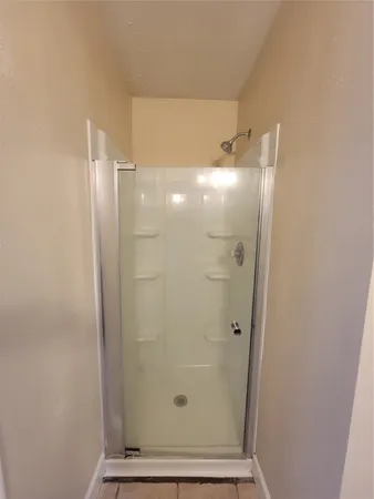 a bathroom with a glass shower door
