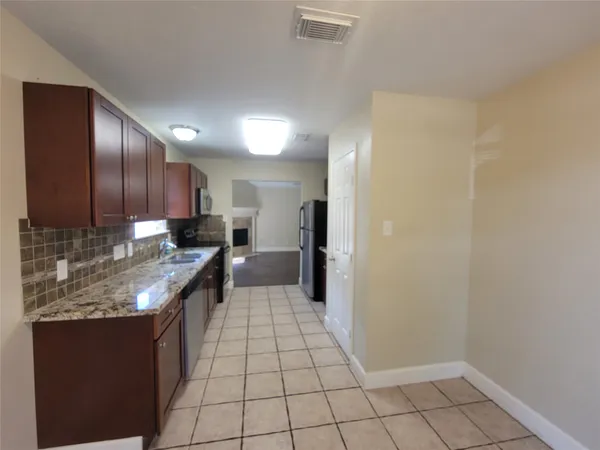 a kitchen with stainless steel appliances granite countertop a sink stove and cabinets