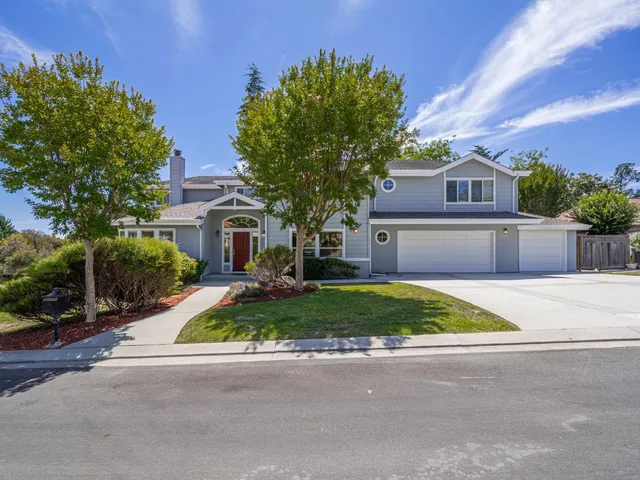 a front view of house with yard and green space
