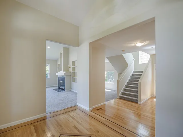 a kitchen with stainless steel appliances granite countertop wooden floors and sink