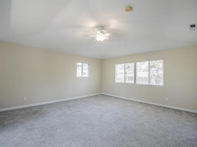 a backyard of a house with yard and outdoor seating