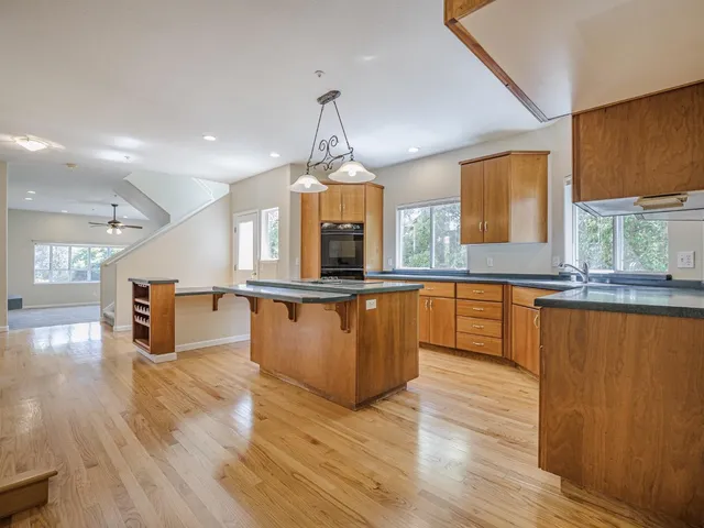a kitchen with stainless steel appliances granite countertop a sink and cabinets