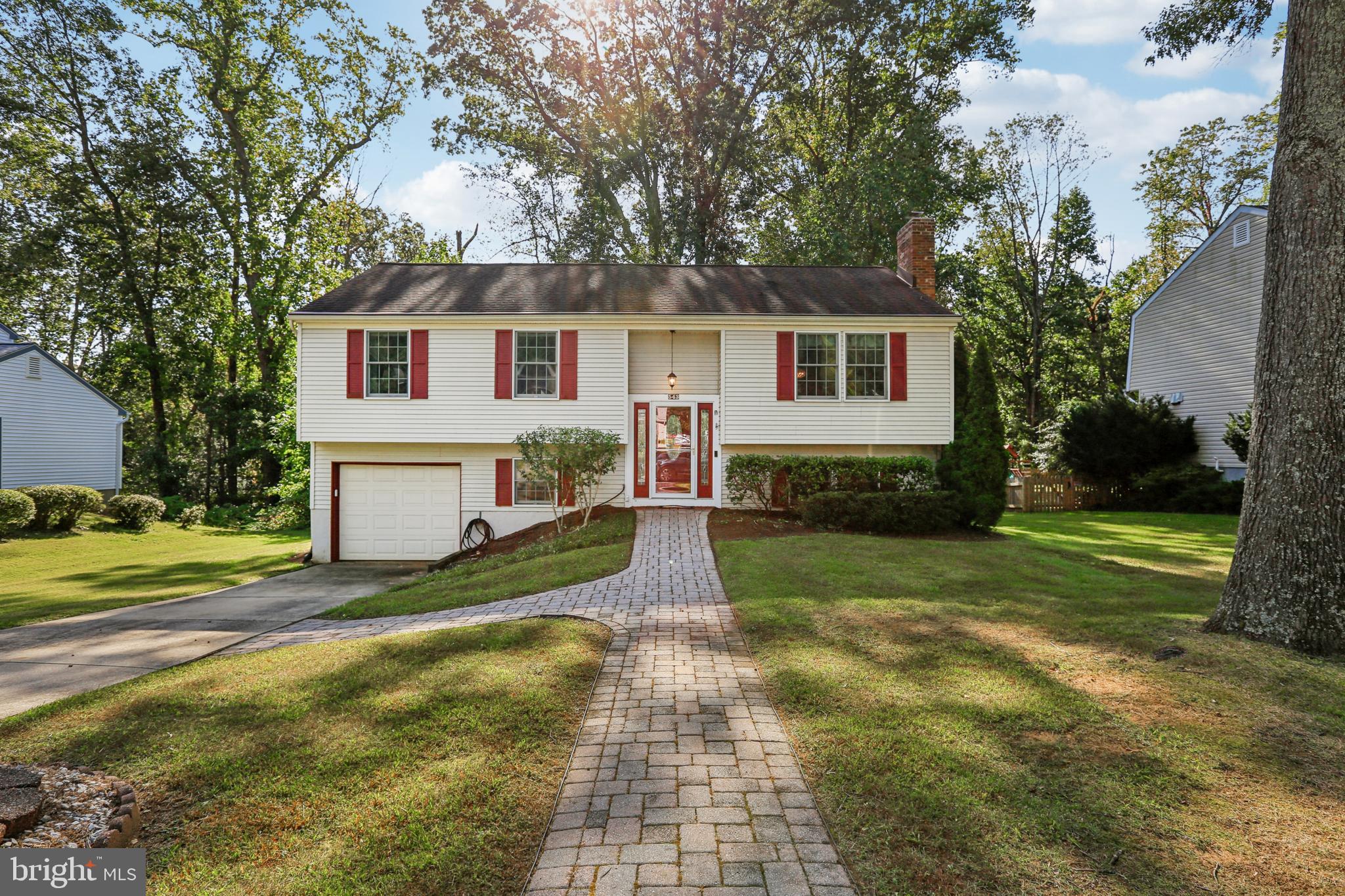 a front view of a house with a yard and trees