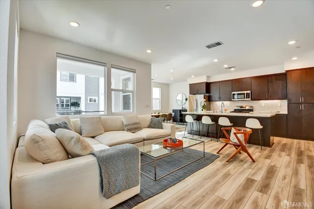 a living room kitchen with furniture and a large window