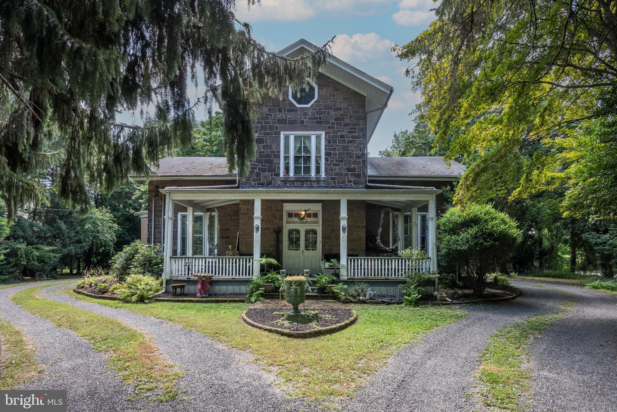 a front view of a house with a yard garage and outdoor seating