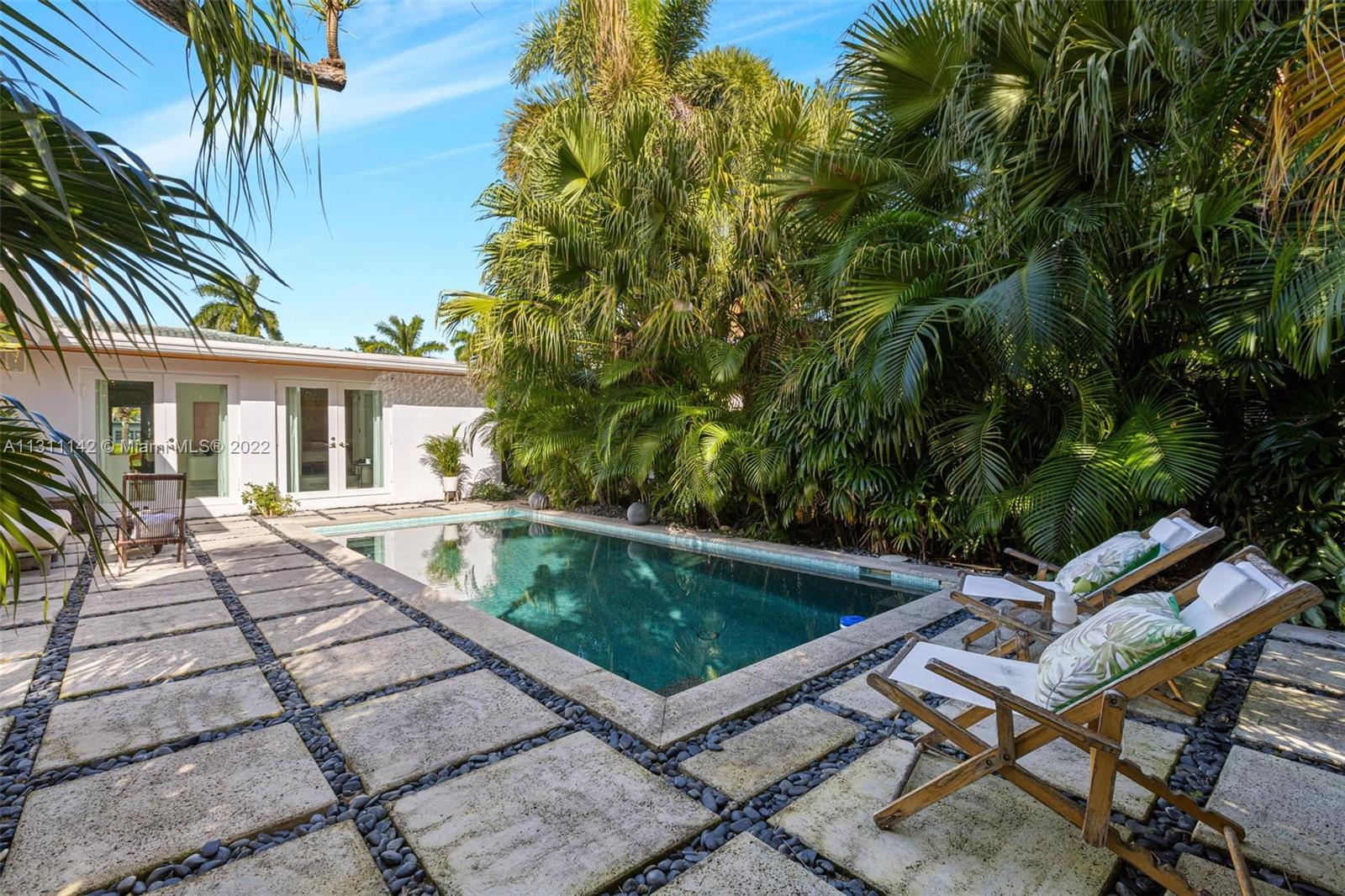 1314 Fillmore Street Hollywood, FL 33019 - Photo 30 of 47 a view of a patio with table and chairs and potted plants