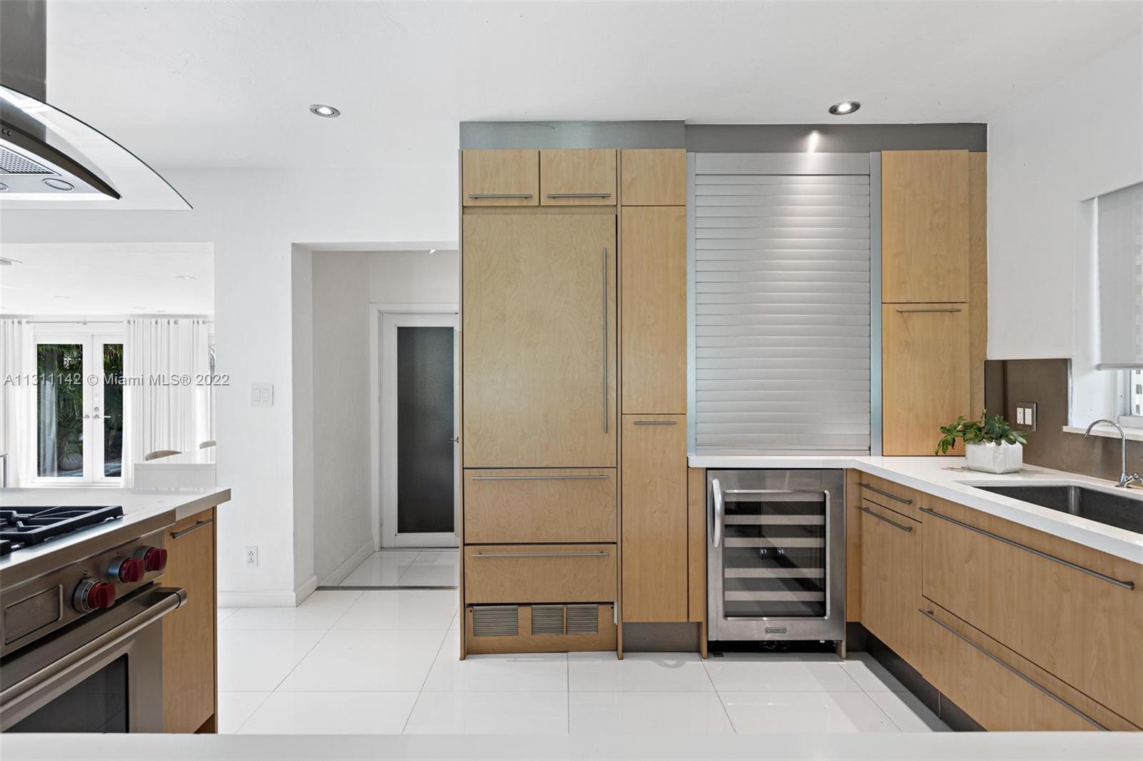 1314 Fillmore Street Hollywood, FL 33019 - Photo 10 of 47 a kitchen with a refrigerator and a stove