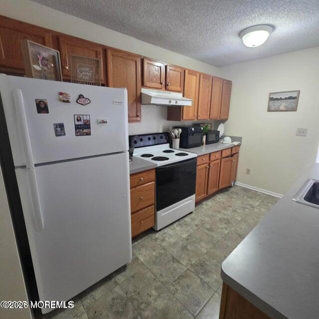 290 North Main Street, Unit D5 Barnegat, NJ 08005 - Photo 1 of 6 a kitchen with stainless steel appliances granite countertop a refrigerator a stove a sink and a more cabinets