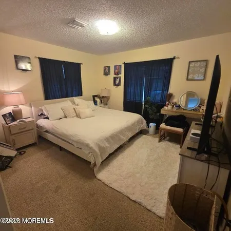 a bed room with a bed window and a chair