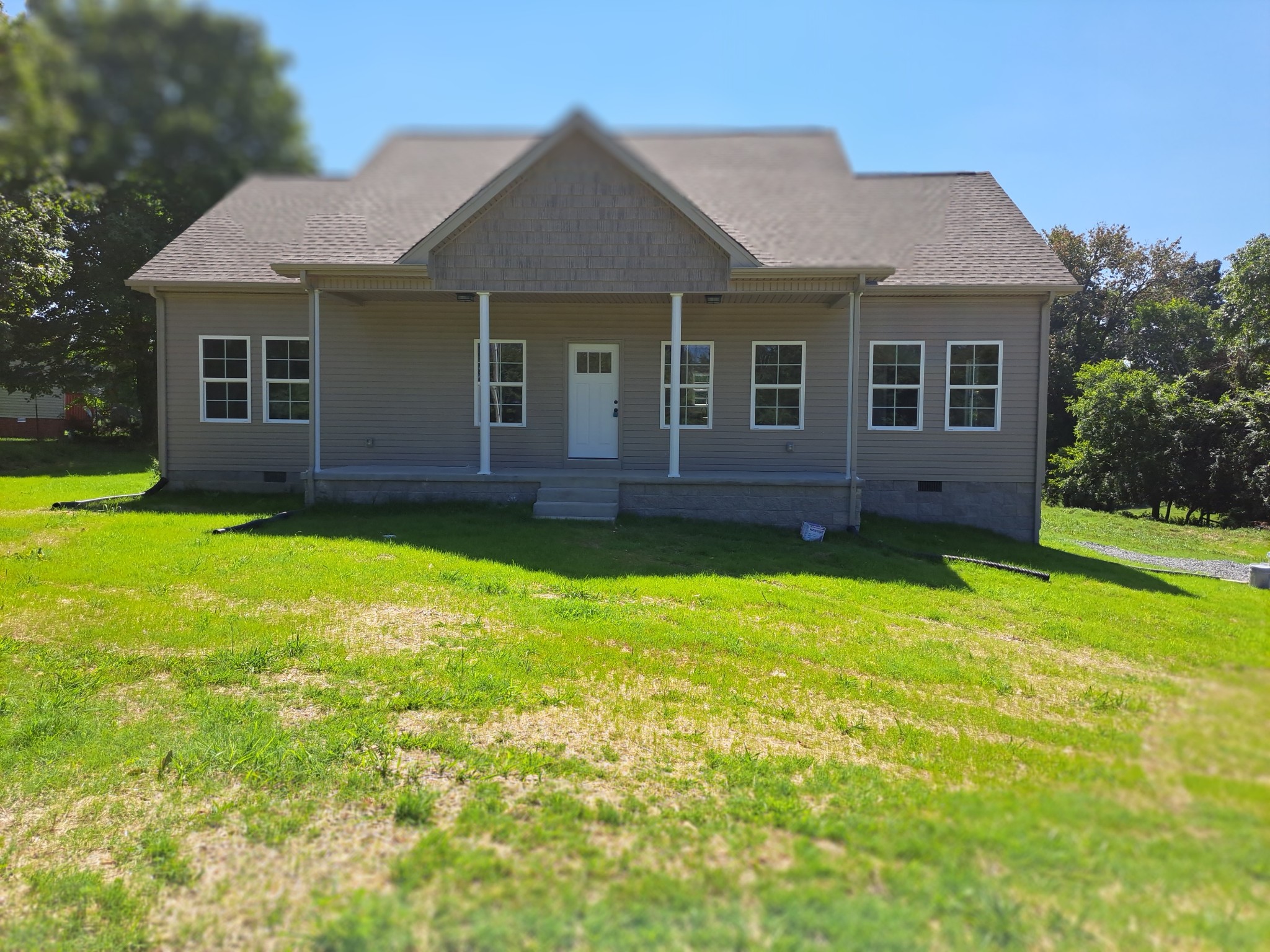 989 Carthage Road Red Boiling Springs, TN 37150 - Photo 1 of 19 a view of a yard in front of a house with plants and large tree