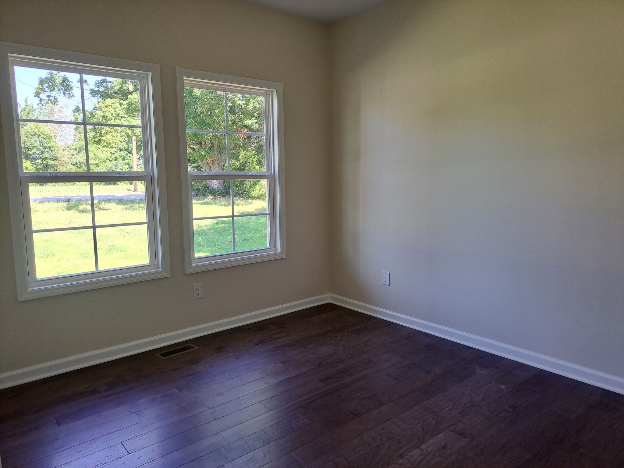 989 Carthage Road Red Boiling Springs, TN 37150 - Photo 12 of 19 a view of an empty room with wooden floor and a window