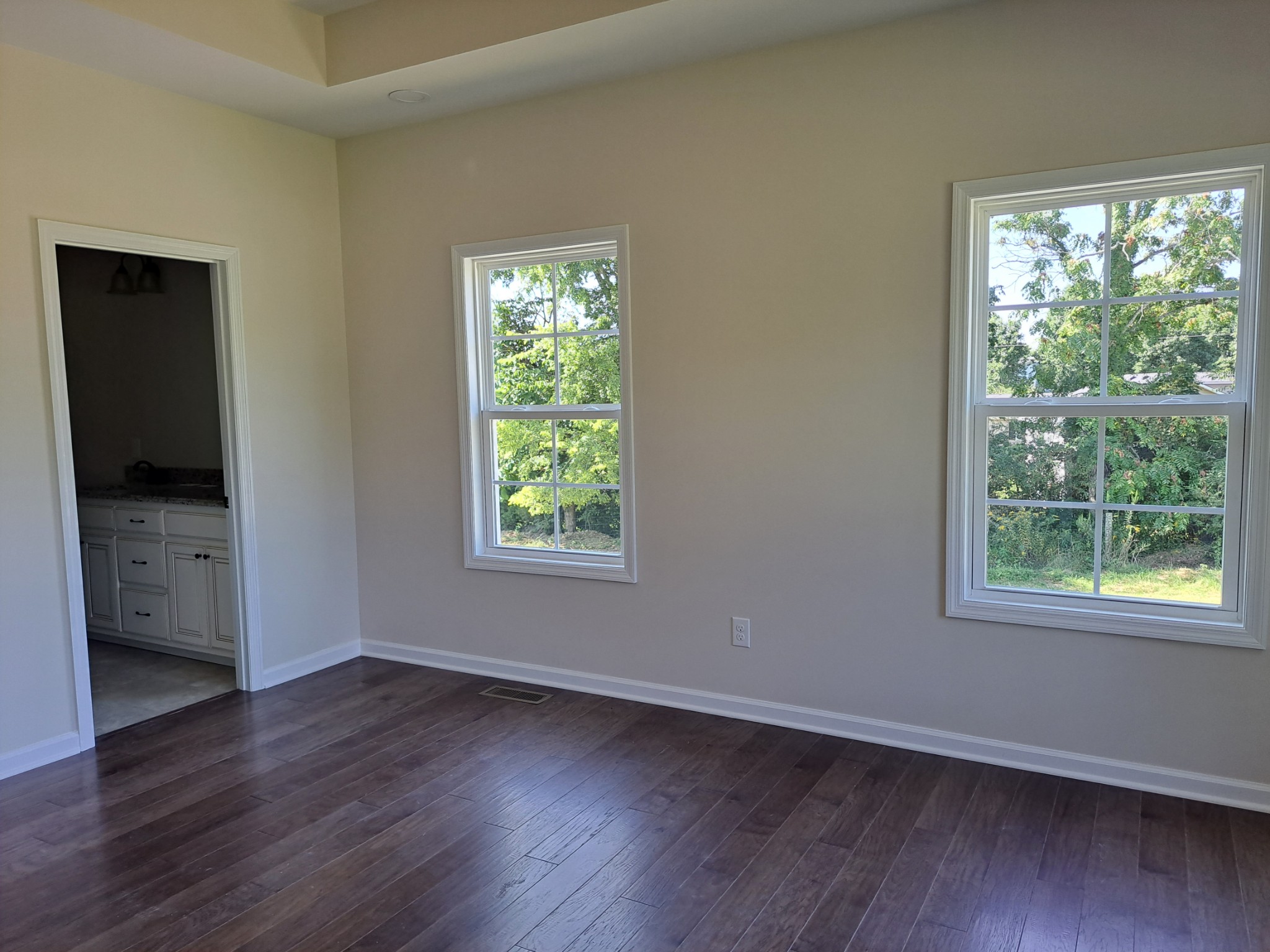 989 Carthage Road Red Boiling Springs, TN 37150 - Photo 14 of 19 an empty room with wooden floor and windows