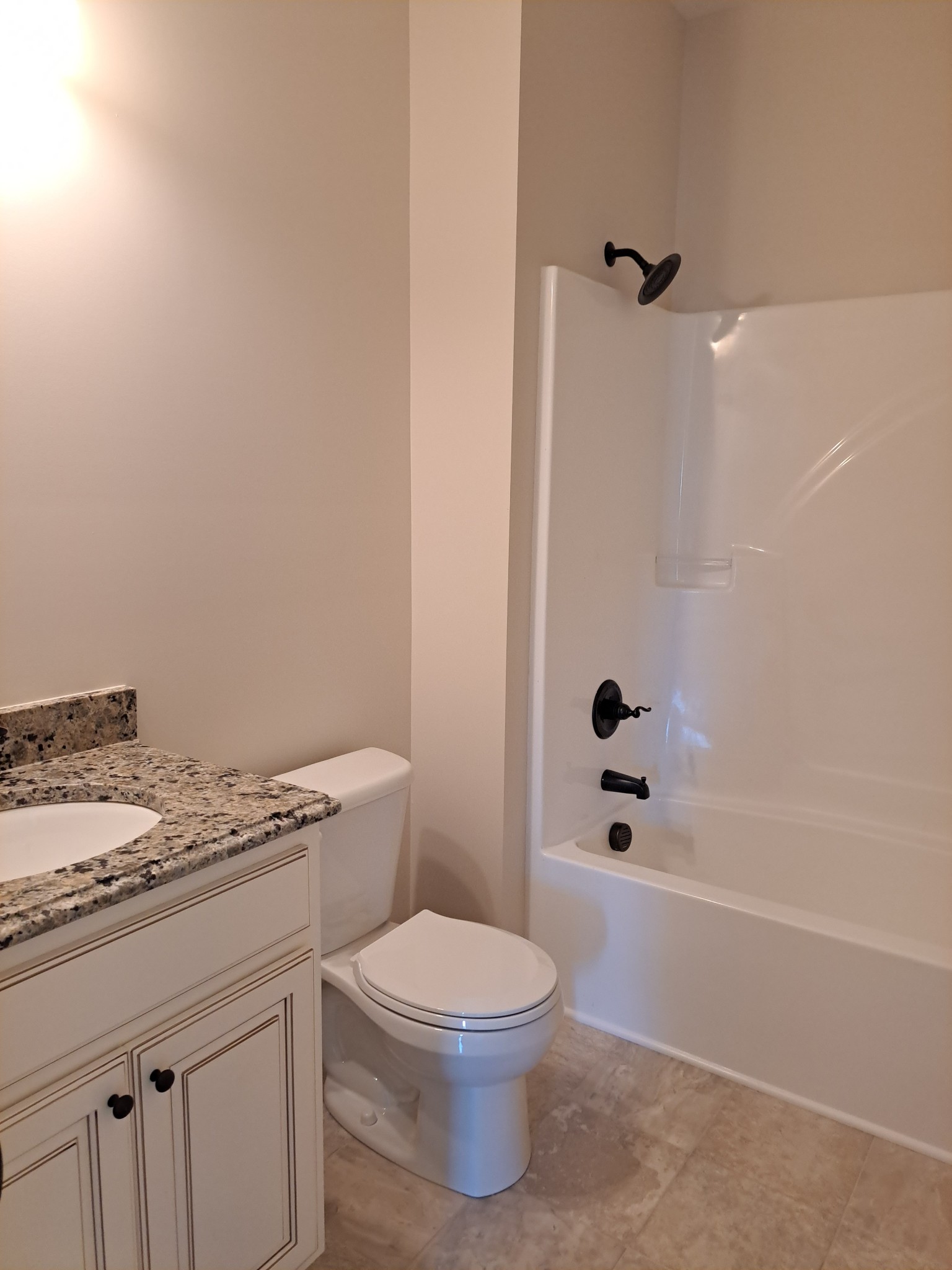 989 Carthage Road Red Boiling Springs, TN 37150 - Photo 19 of 19 a bathroom with a granite countertop toilet a sink and shower