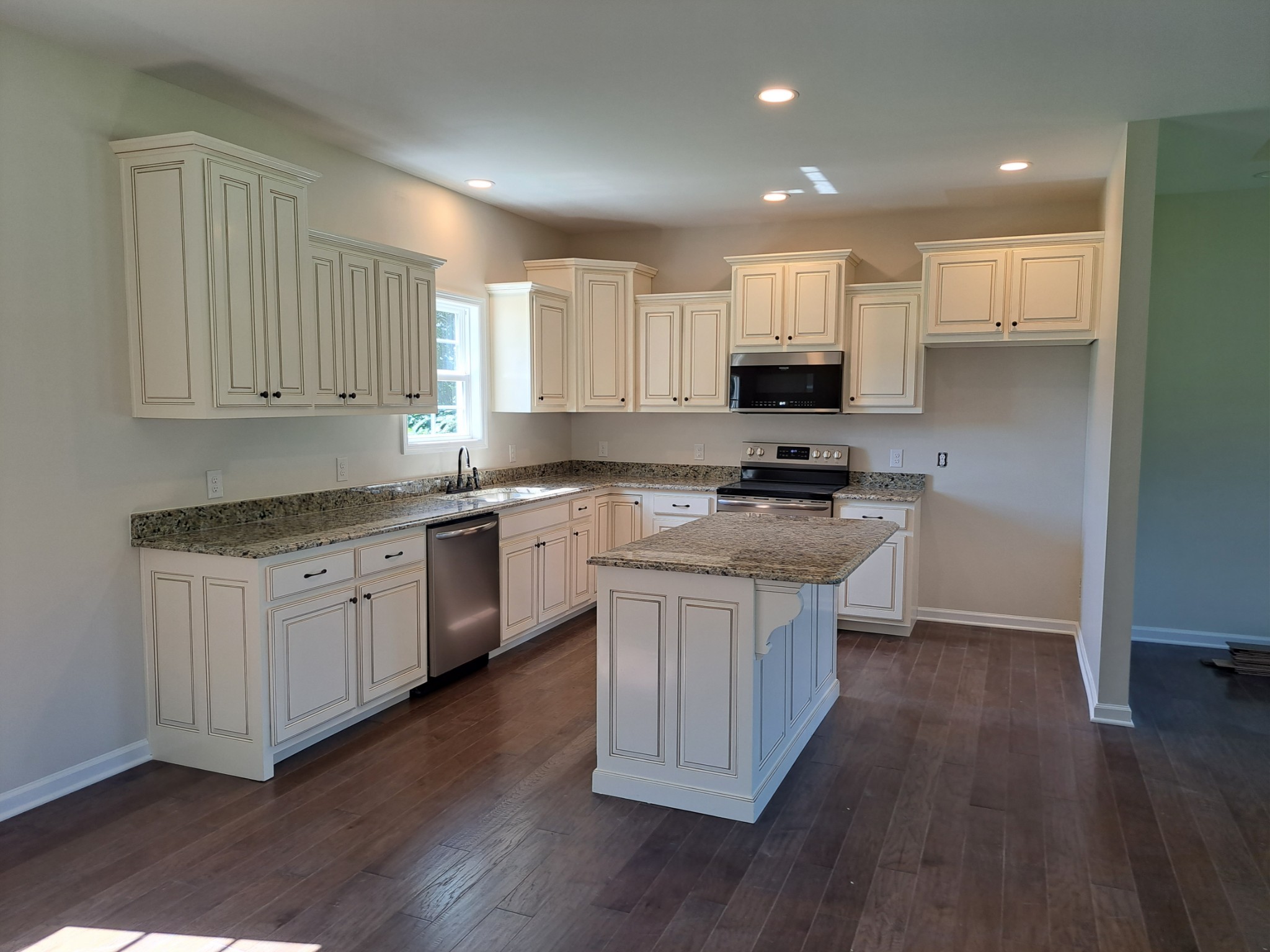 989 Carthage Road Red Boiling Springs, TN 37150 - Photo 7 of 19 a kitchen with granite countertop a sink cabinets and wooden floor