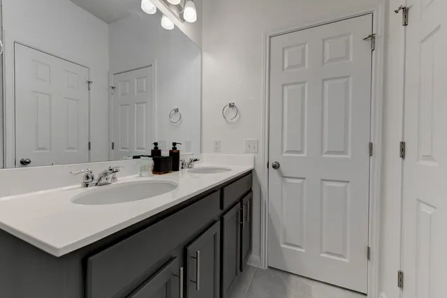 a bathroom with a sink vanity and a mirror