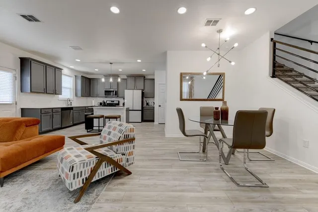 a living room with furniture and kitchen view