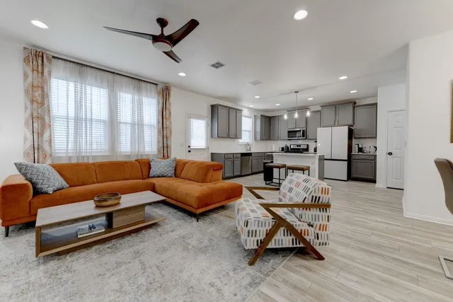 a living room with furniture and a wooden floor