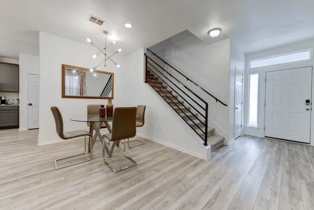 a view of a workspace with furniture and stairs