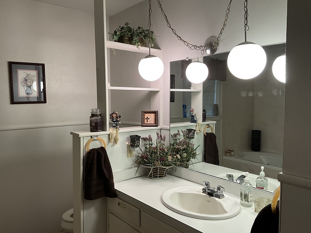 416 Division Street Jewett, TX 75846 - Photo 17 of 36 a bathroom with a sink and a mirror