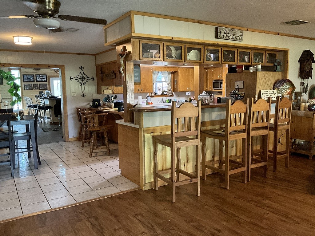 416 Division Street Jewett, TX 75846 - Photo 7 of 36 a view of a dining area with lots of wooden furniture