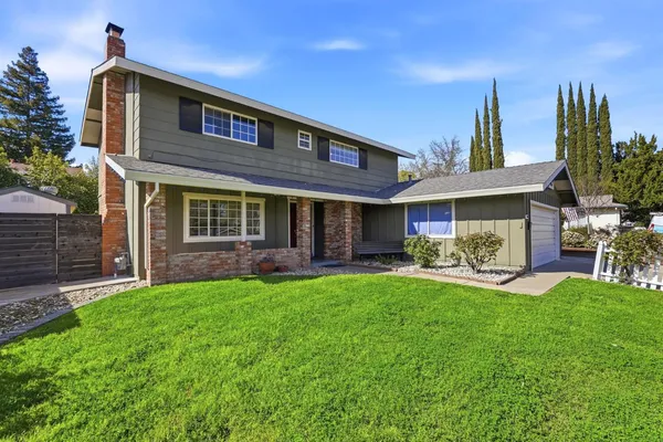 a view of a house with a yard porch and sitting area