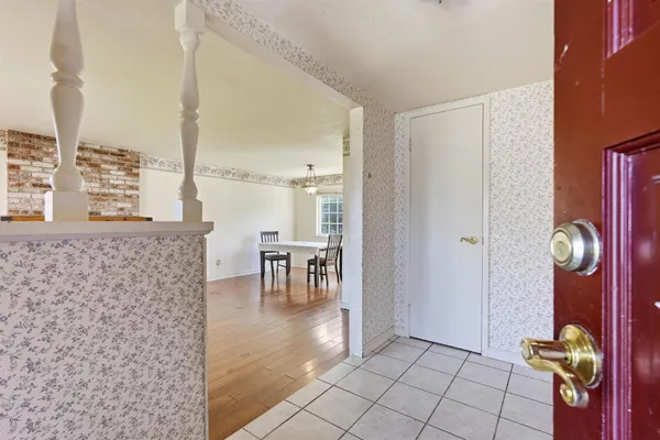a view of empty room with wooden floor and windows