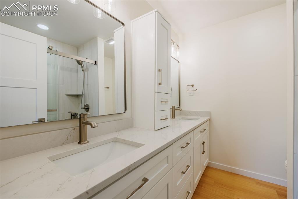 2905 Mesa Road, Unit D Colorado Springs, CO 80904 - Photo 25 of 34 a bathroom with a double vanity sink and a mirror
