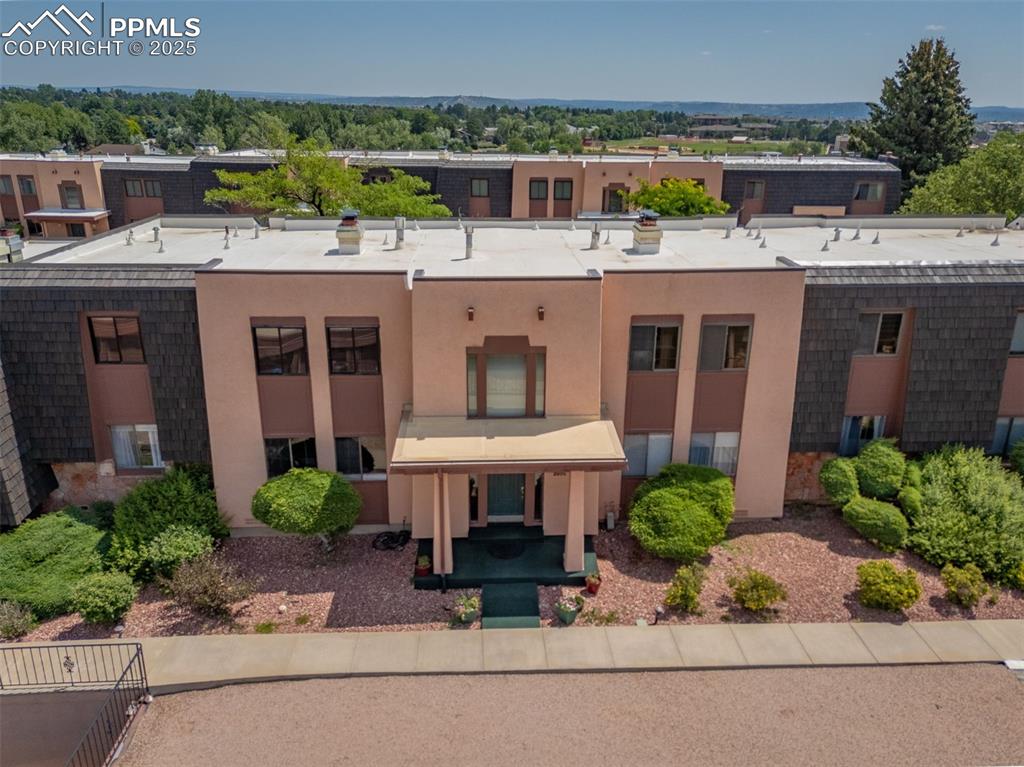 2905 Mesa Road, Unit D Colorado Springs, CO 80904 - Photo 4 of 34 a view of a patio with a table and chairs under an umbrella