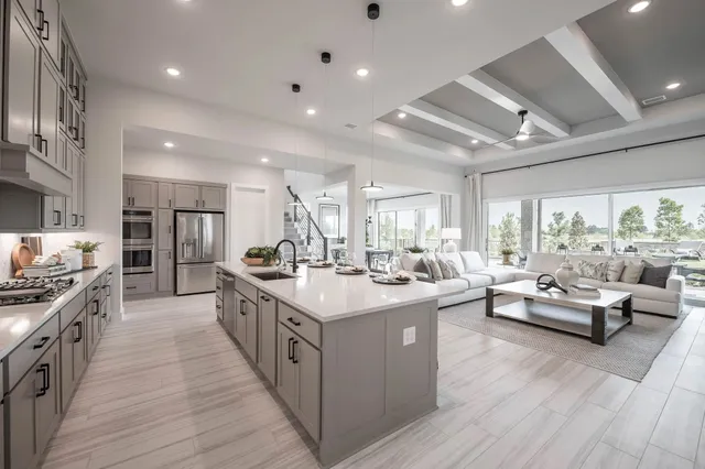 a large kitchen with stainless steel appliances lots of counter space and a wooden floors