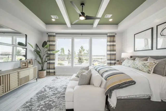 a spacious bedroom with a large bed and a large window