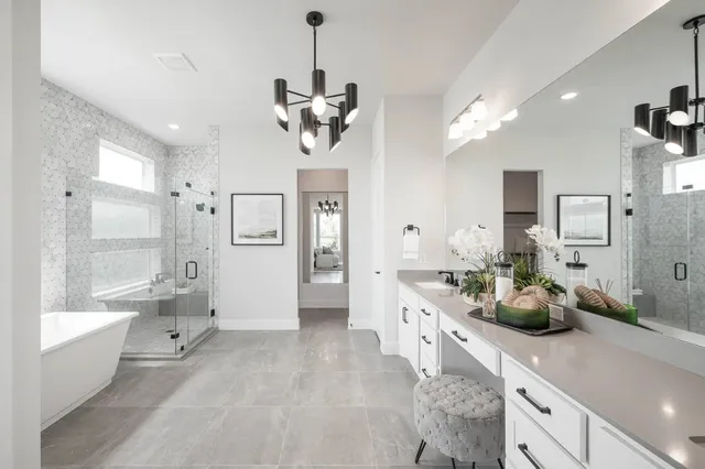 a large room with a lot of white cabinets and stainless steel appliances