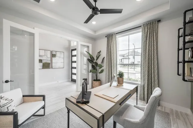 a living room with furniture a rug and a large window