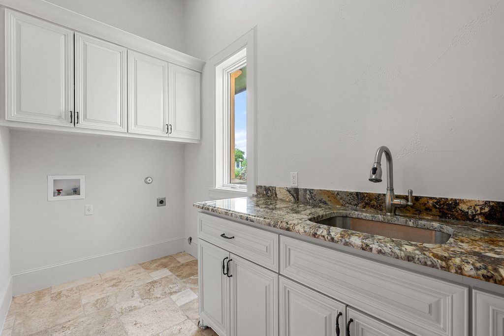 102 Long Point Cove Georgetown, TX 78628 - Photo 33 of 36 a kitchen with a sink and cabinets