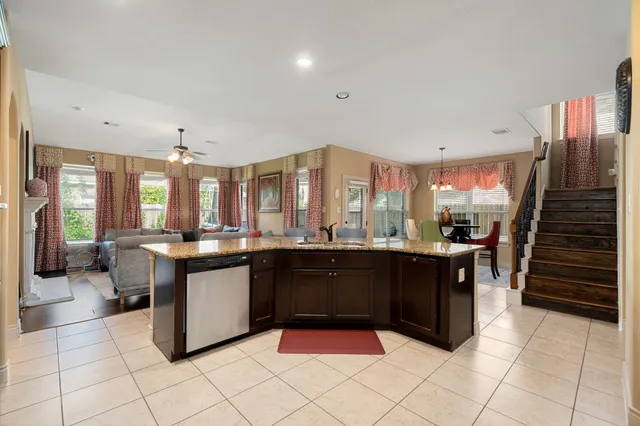 a large kitchen with kitchen island granite countertop a large counter top and stainless steel appliances
