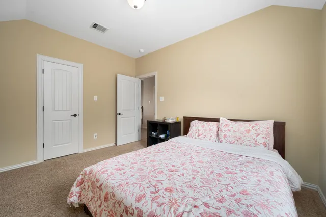 a bedroom with a bed and a night stand