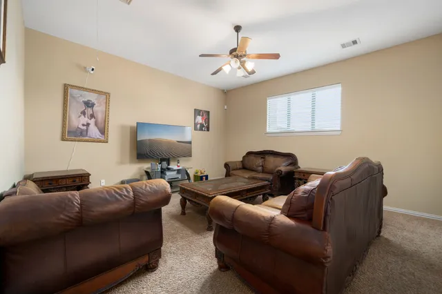 a living room with furniture and a chandelier