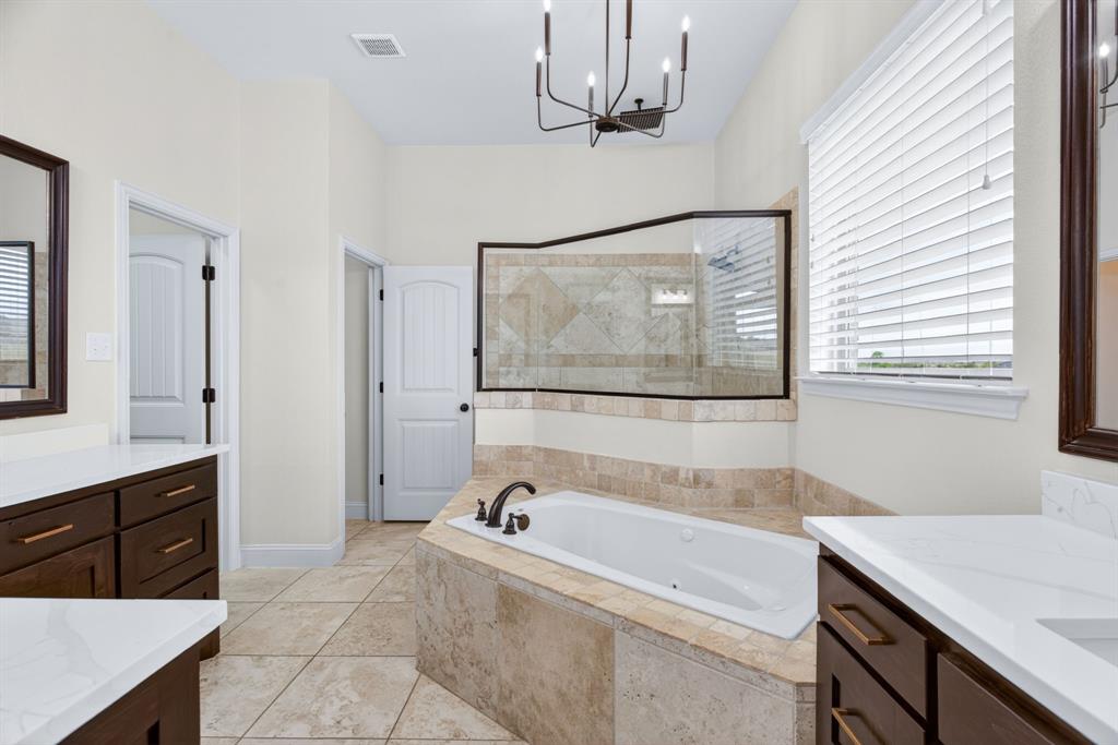 7320 Spring Ranch Court Godley, TX 76044 - Photo 23 of 38 a bathroom with a tub sink and mirror
