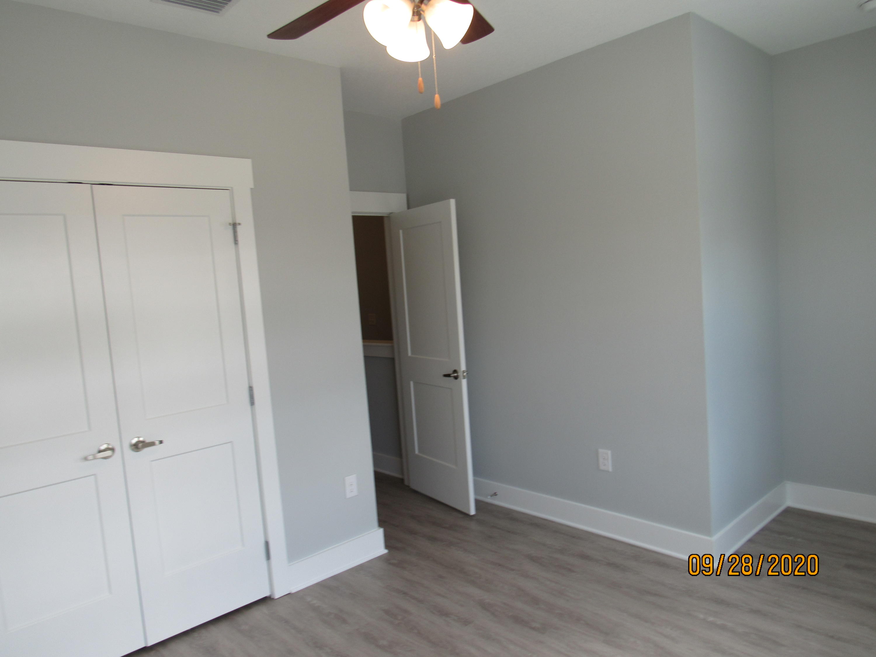 45 South Sand Palm Road Freeport, FL 32439 - Photo 15 of 19 a view of an empty room with wooden floor and a chandelier fan