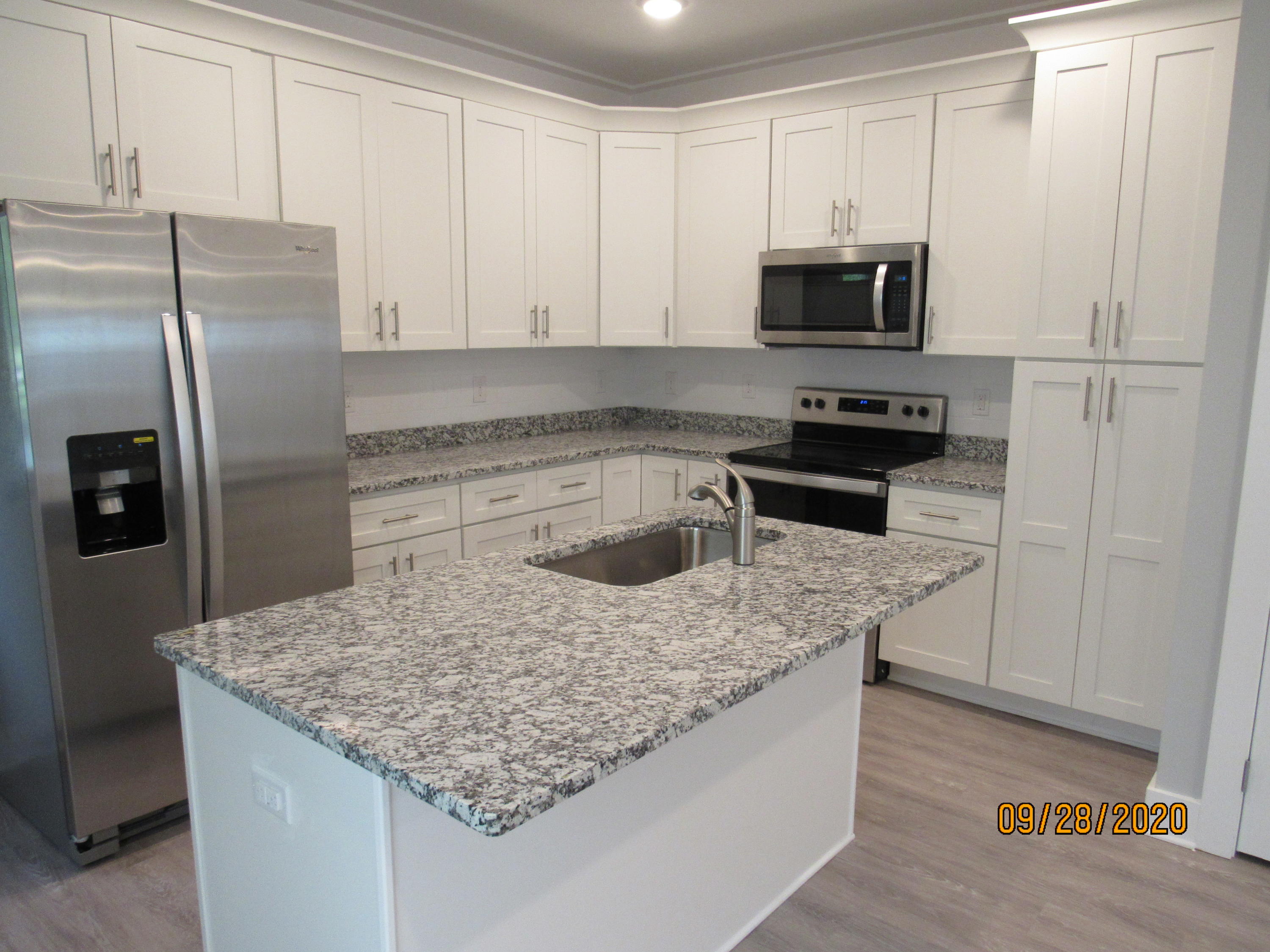 45 South Sand Palm Road Freeport, FL 32439 - Photo 2 of 19 a kitchen with stainless steel appliances granite countertop a sink stove and refrigerator
