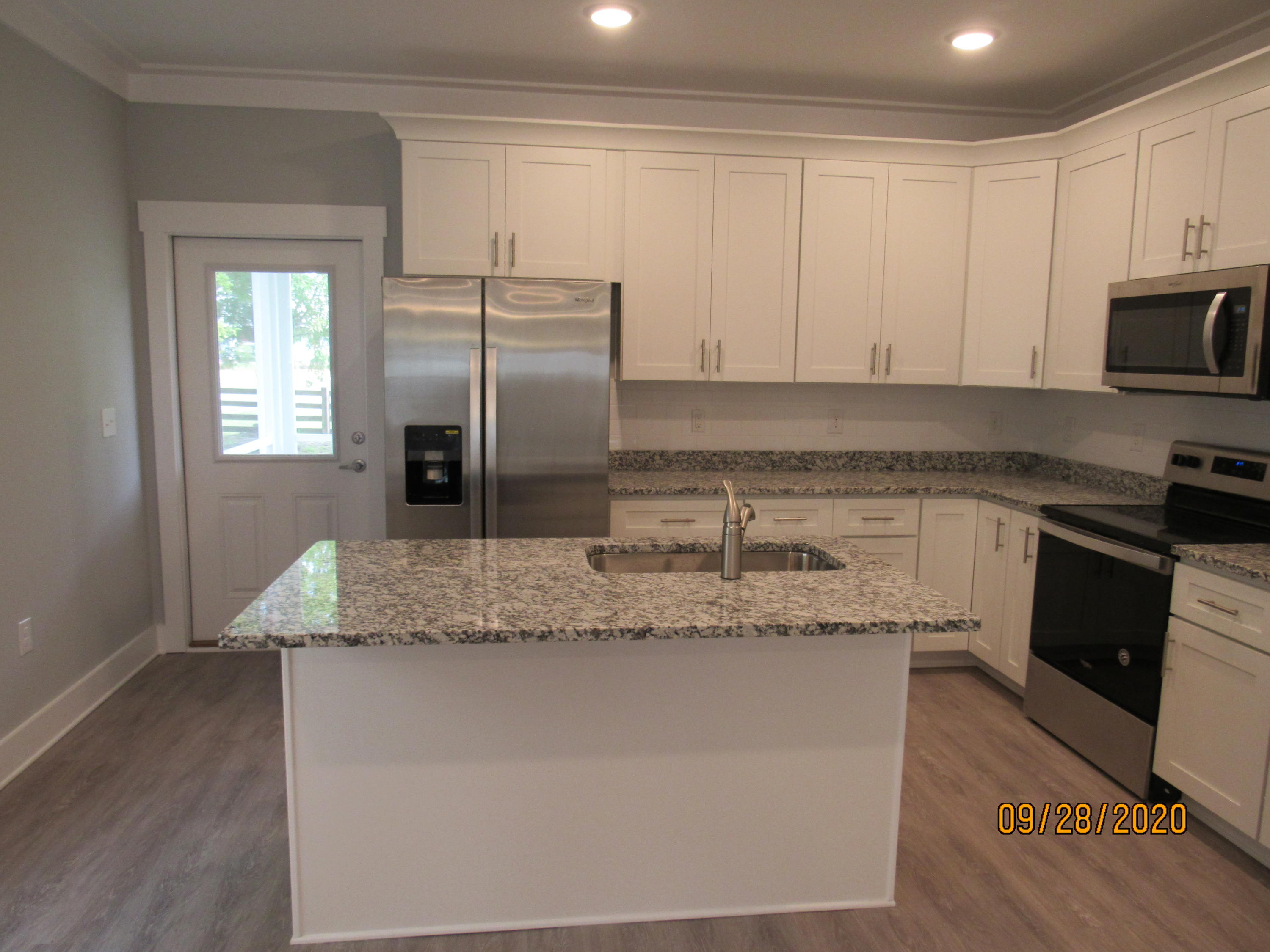 45 South Sand Palm Road Freeport, FL 32439 - Photo 3 of 19 a kitchen with stainless steel appliances granite countertop a sink a stove and a refrigerator