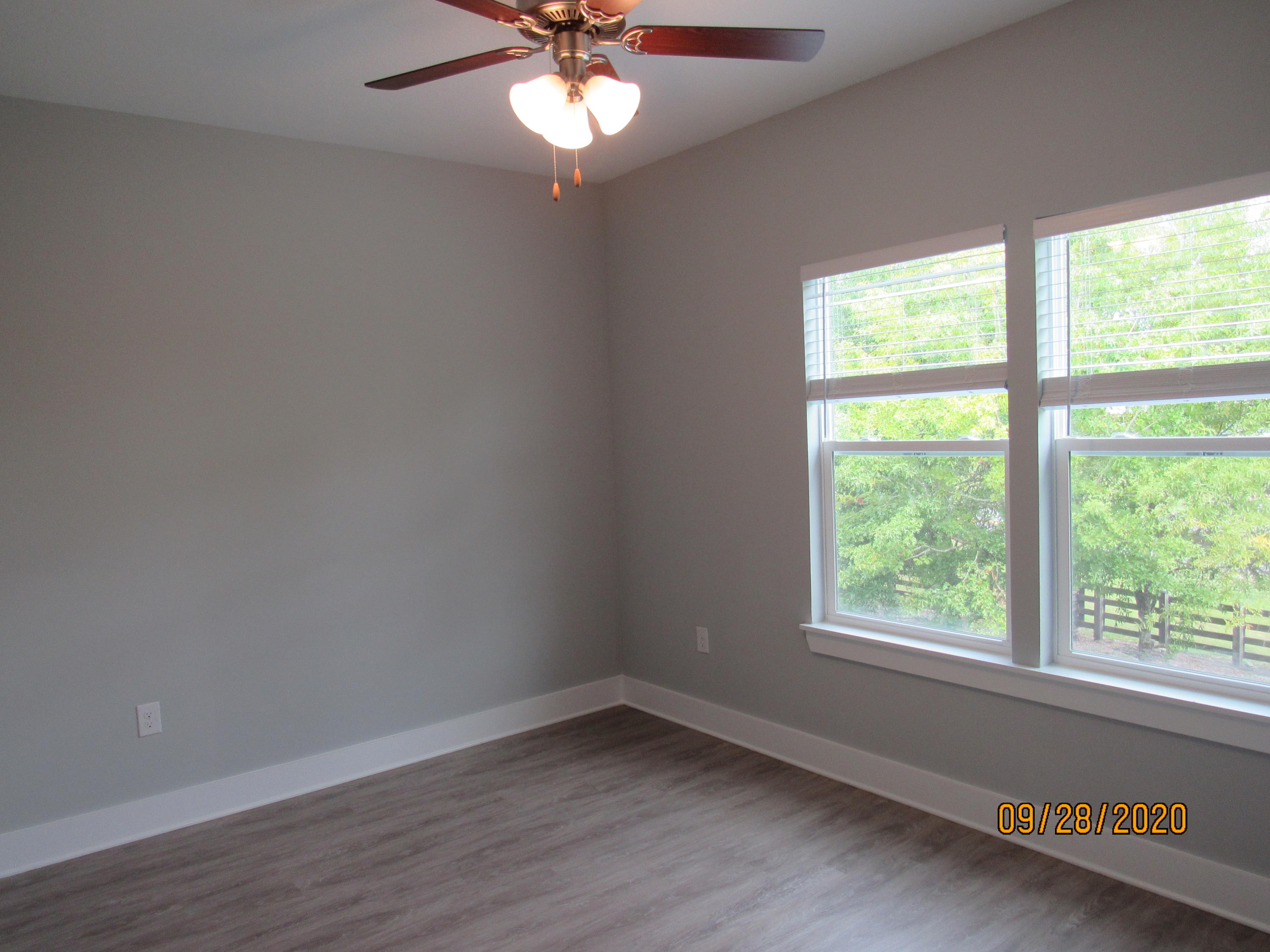 45 South Sand Palm Road Freeport, FL 32439 - Photo 8 of 19 a view of an empty room with wooden floor and a window