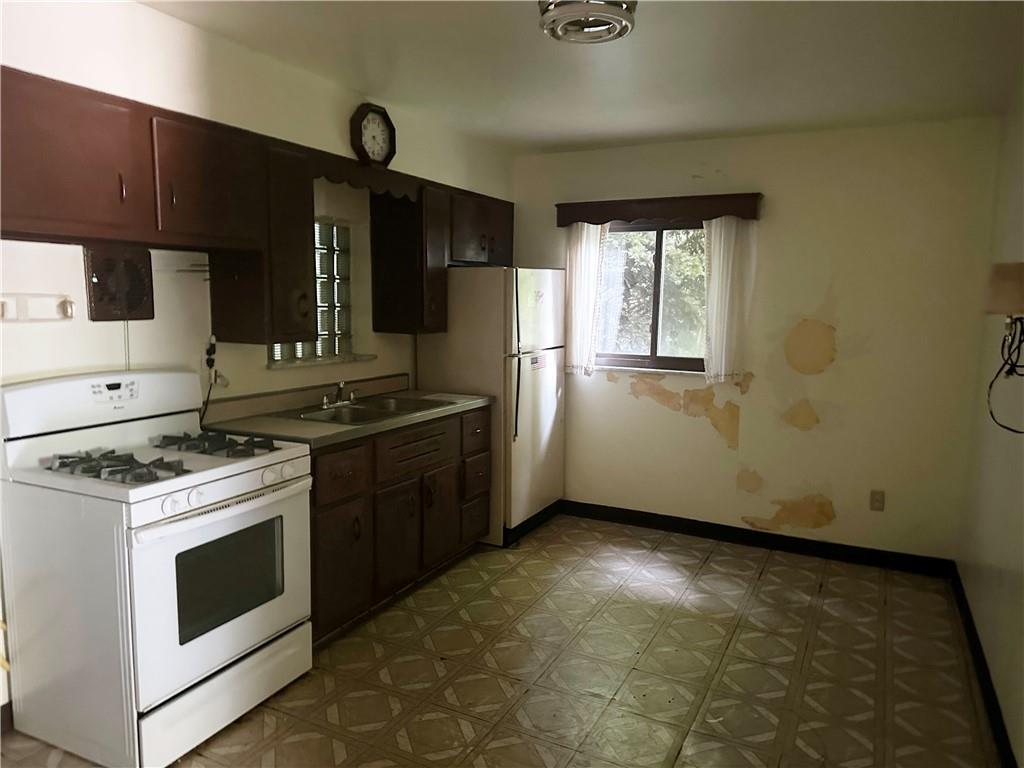 998 Chartiers Avenue Carnegie, PA 15106 - Photo 5 of 10 a kitchen with a stove top oven cabinets and stainless steel appliances