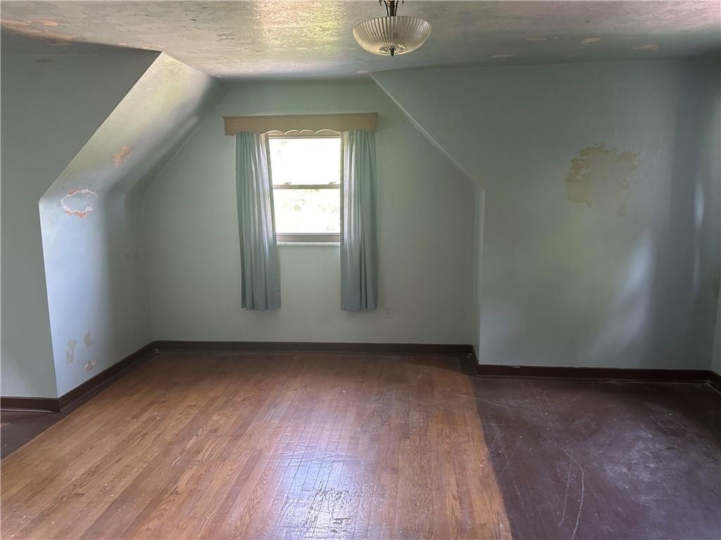 998 Chartiers Avenue Carnegie, PA 15106 - Photo 7 of 10 an empty room with wooden floor and windows