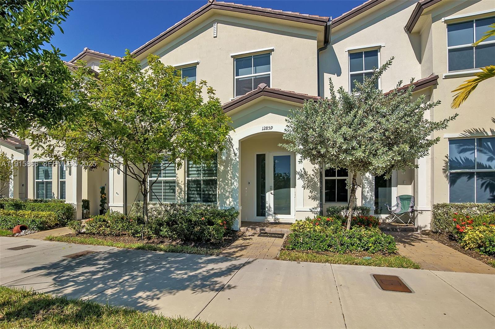 front view of a brick house with a small yard