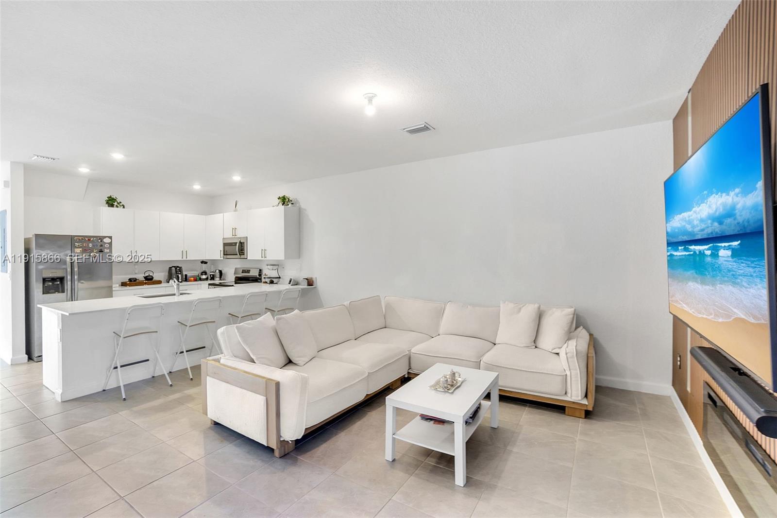 12859 Southwest 243rd Terrace Homestead, FL 33032 - Photo 11 of 38 a living room with furniture and a kitchen view