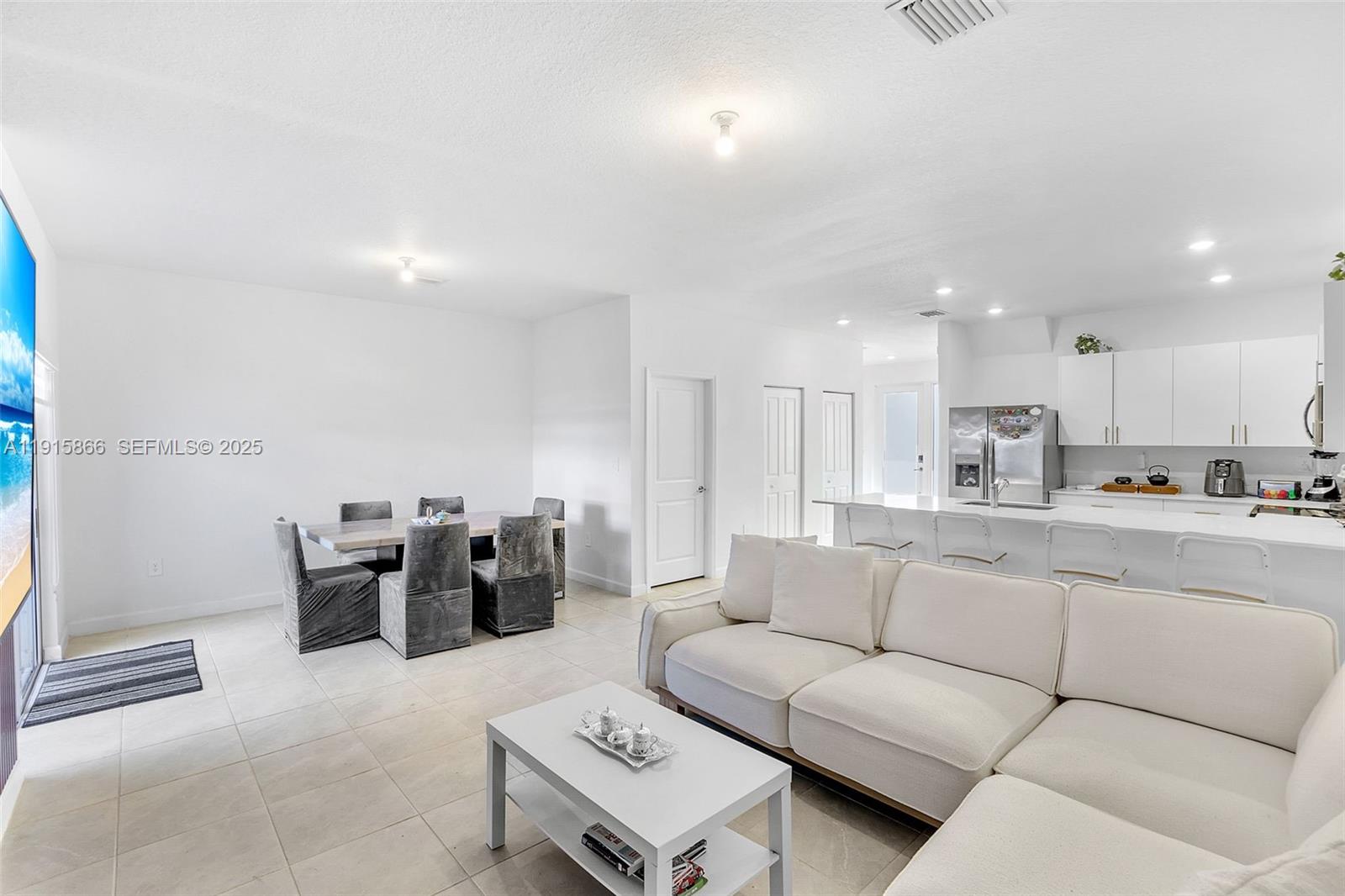12859 Southwest 243rd Terrace Homestead, FL 33032 - Photo 12 of 38 a living room with furniture and view of kitchen