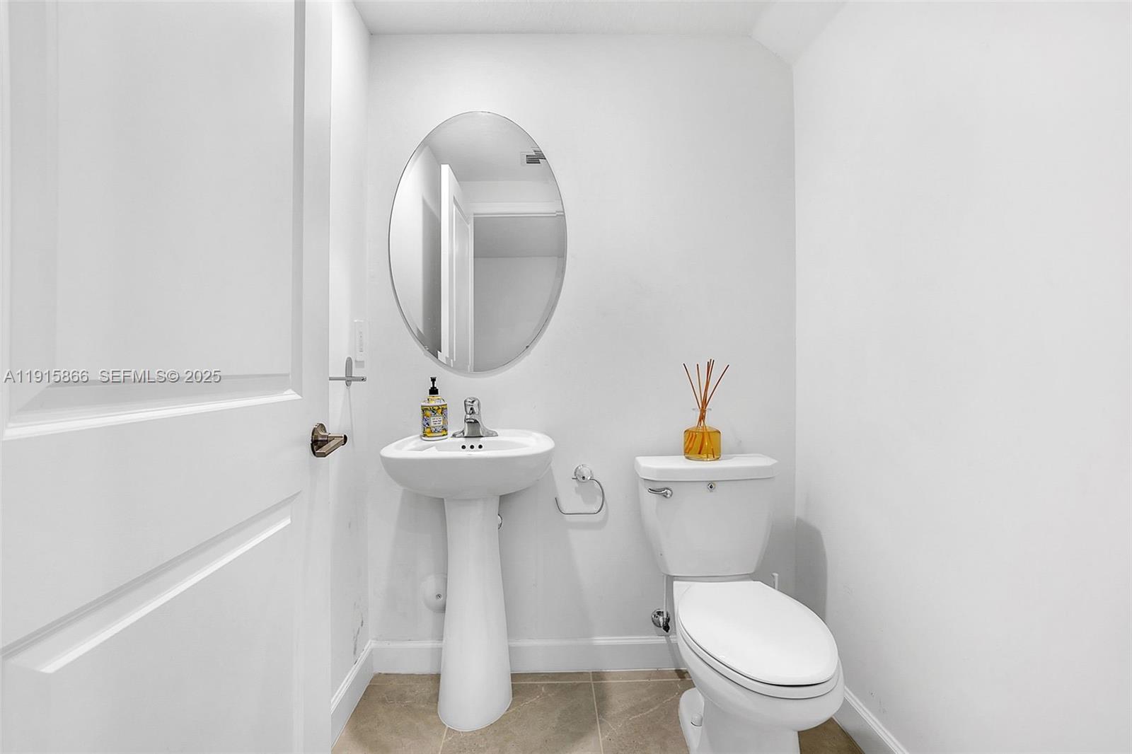 12859 Southwest 243rd Terrace Homestead, FL 33032 - Photo 14 of 38 a bathroom with a toilet a sink and mirror